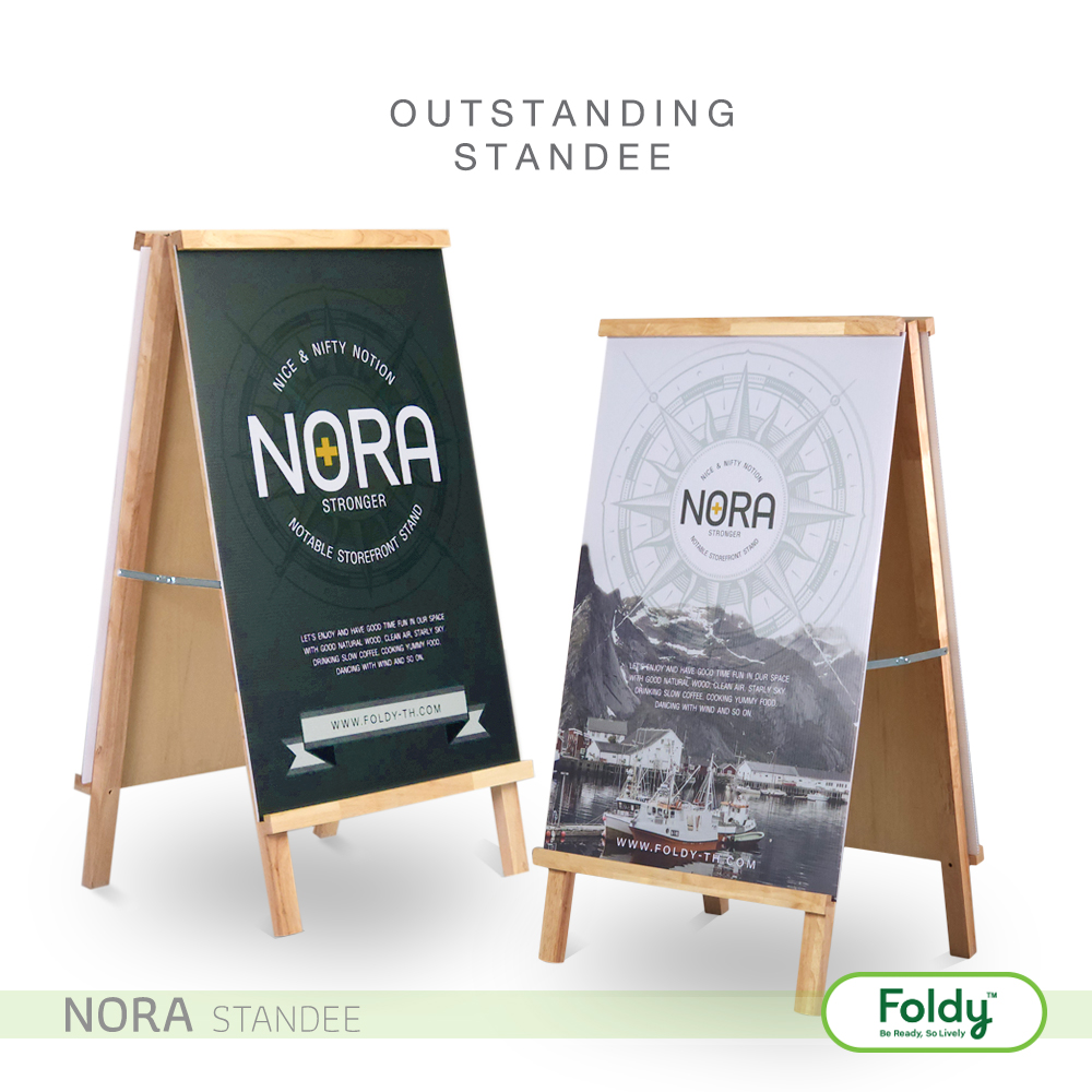 Two wooden A-frame standees displaying NORA banners; promotional signs with 'Outstanding Standee' text above and Foldy logo nearby.
