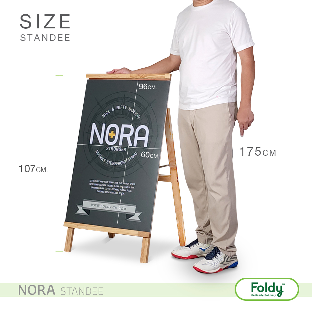 Man standing next to a Nora Standee chalkboard on a wooden easel; board shows 96 cm width and 60 cm height, with a 175 cm man for scale; "NORA STANDEE" branding at bottom left and Foldy logo bottom right.